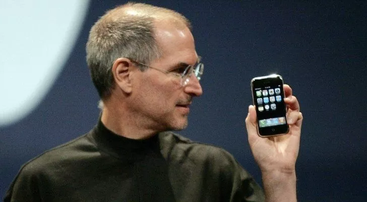 Стив Джобс держит самый первый iPhone